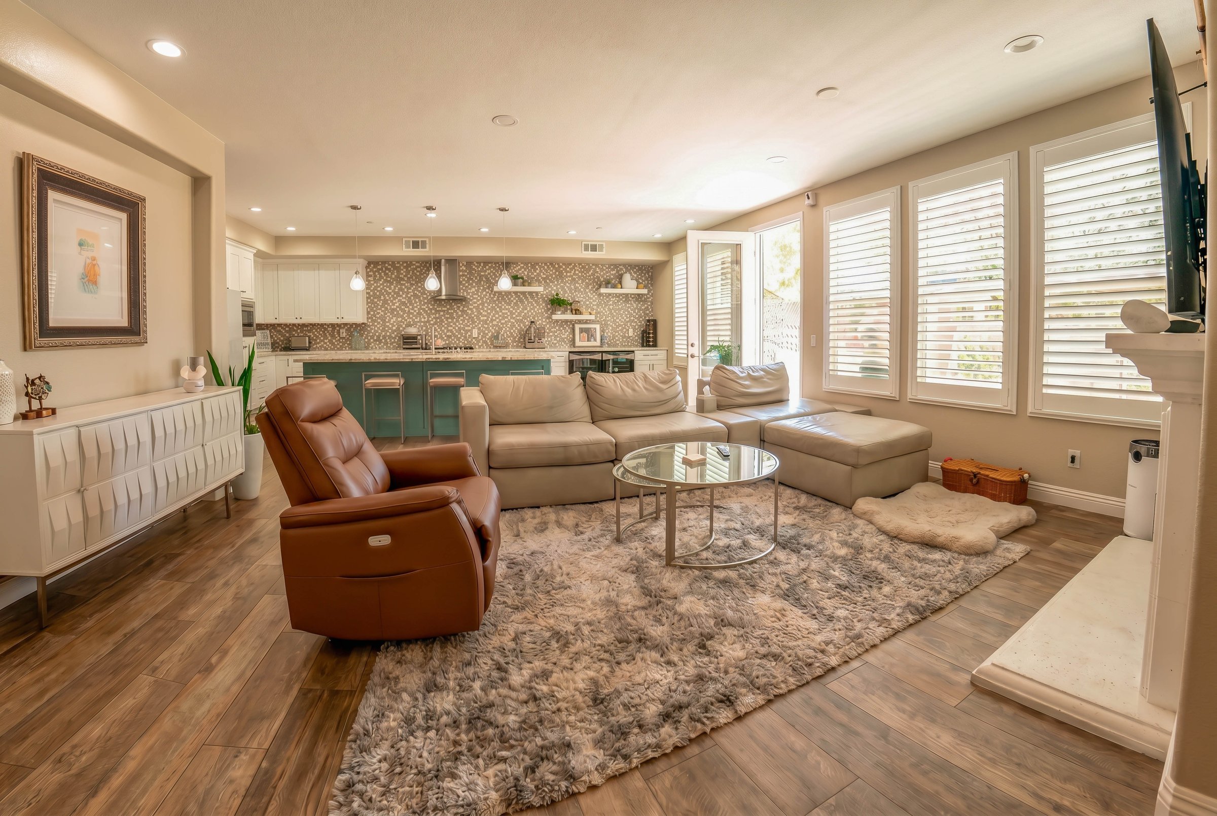 Main living room with kitchen visible behind